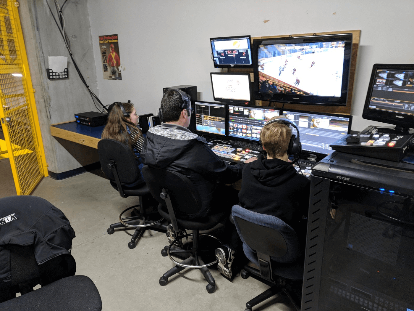 Три человека работают за экранами мониторов